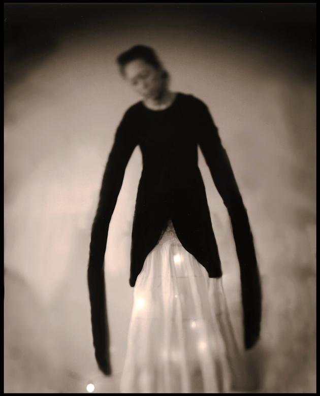 black and white photo of woman with long arms 