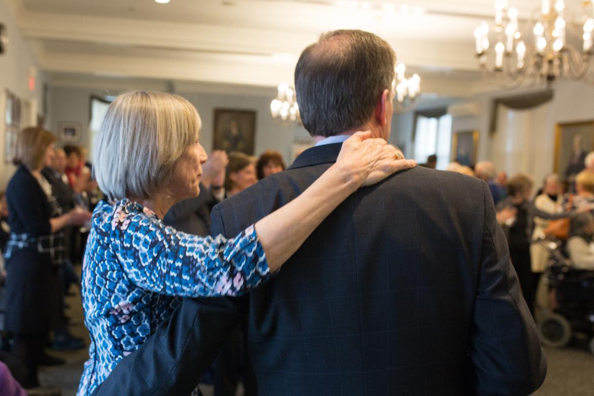 Beth Chiquoine puts her arm around President Moore