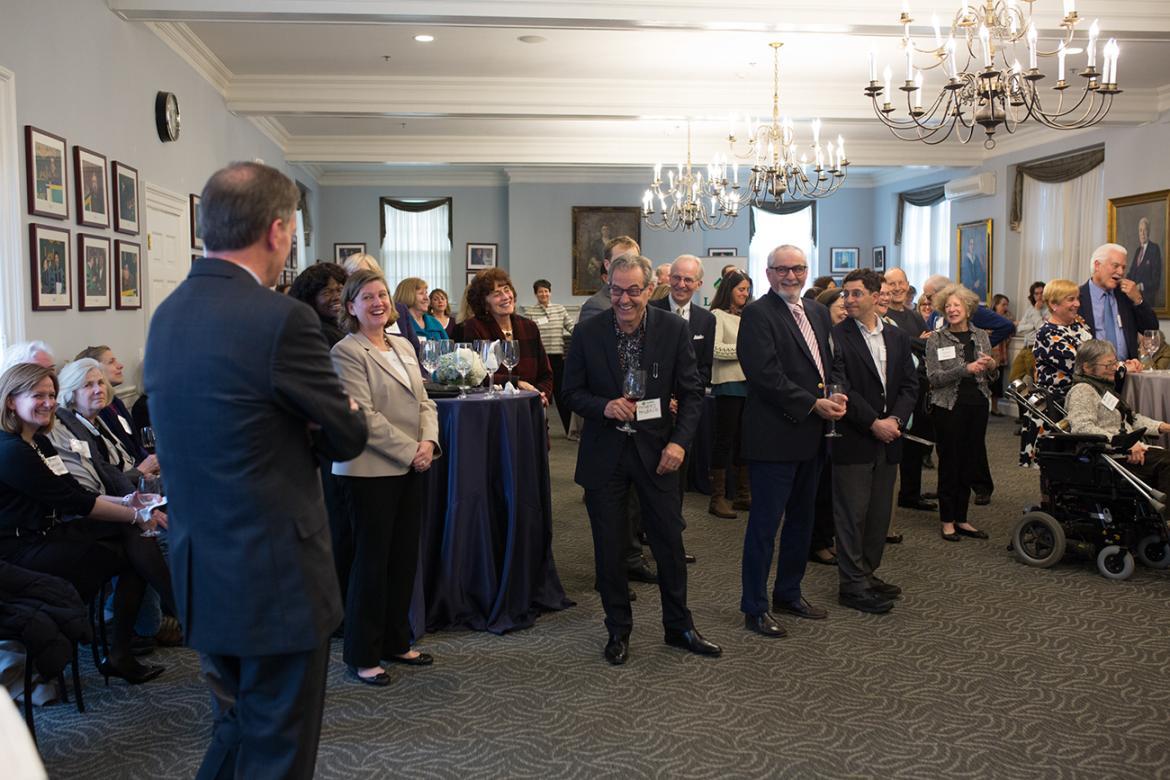 People gather and applaud in Alumni Hall.