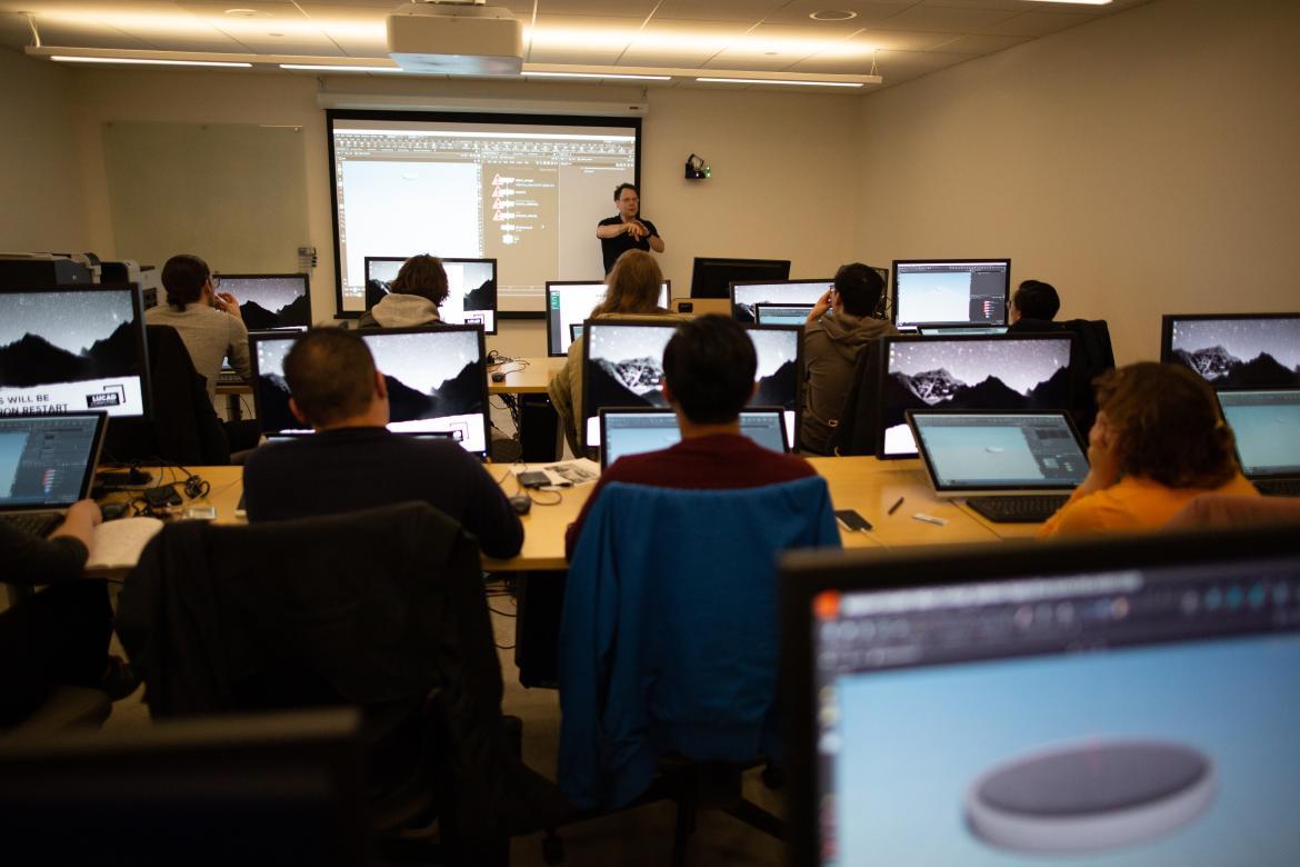 teacher giving a lecture in a computer lab