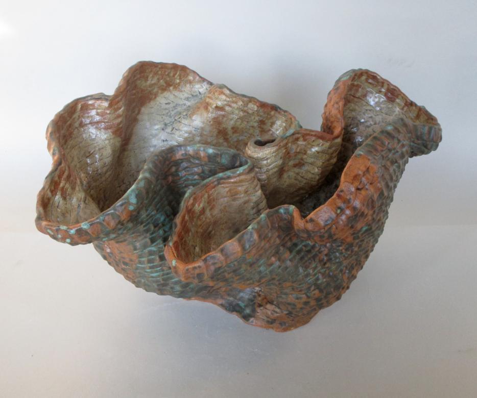 brownish gray ceramic bowl that kind of looks like a shell