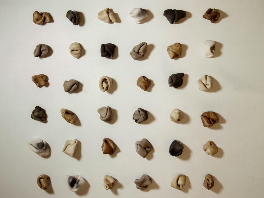 36 ceramic knots screwed into a wall