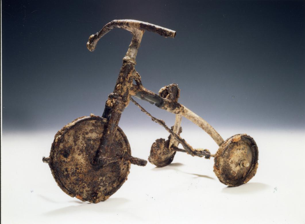 A heavily rusted tricycle