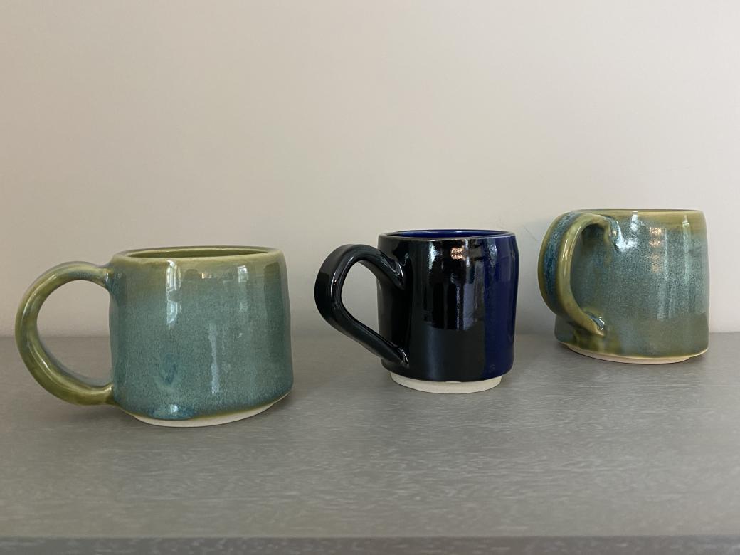 Three finished blue mugs.