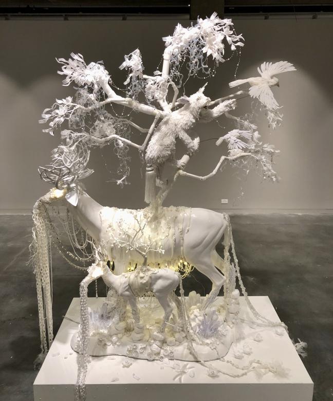 white sculpture of animals made out of different materials