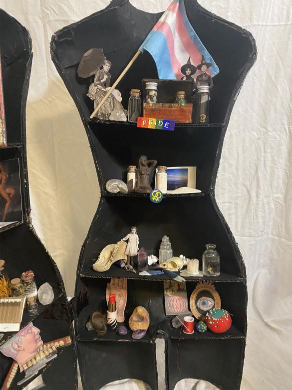 close-up of left half of mannequin, containing trinkets