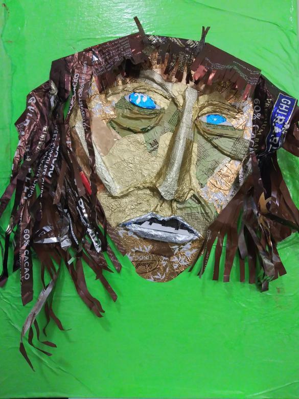 A person's head made out of recycled candy wrappers