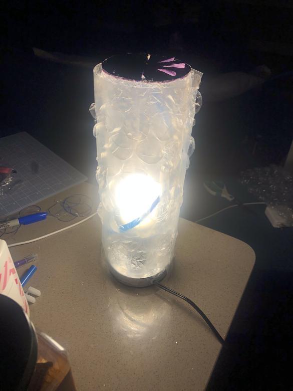 Homemade lamp on a table, lit up