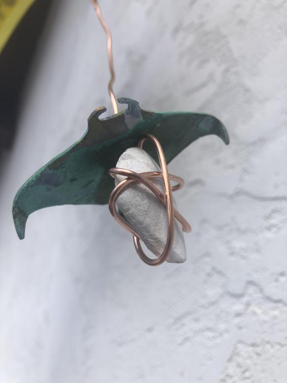 Close-up of shells, copper wire and blue/green metal sting rays