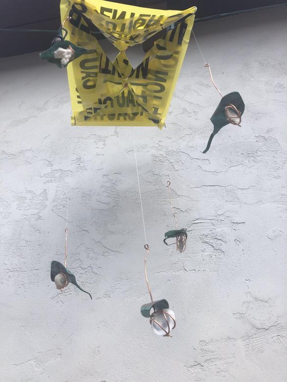 Hanging mobile with caution tape, shells, copper wire and blue/green metal sting rays