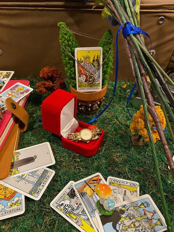 Close-up of watch, tarot cards and trinkets