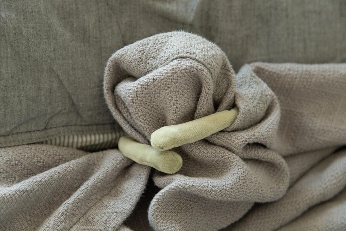 frog stuffed animal covering its face with a blanket