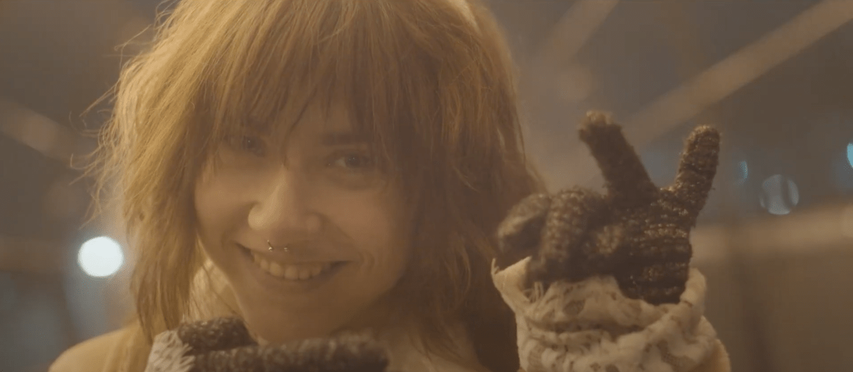 Close up of a girl with bangs smiling.