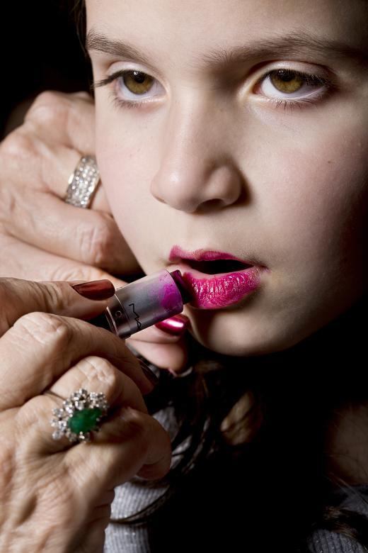 Elinor Carucci's photo "Grandma puts on the lipstick, again"