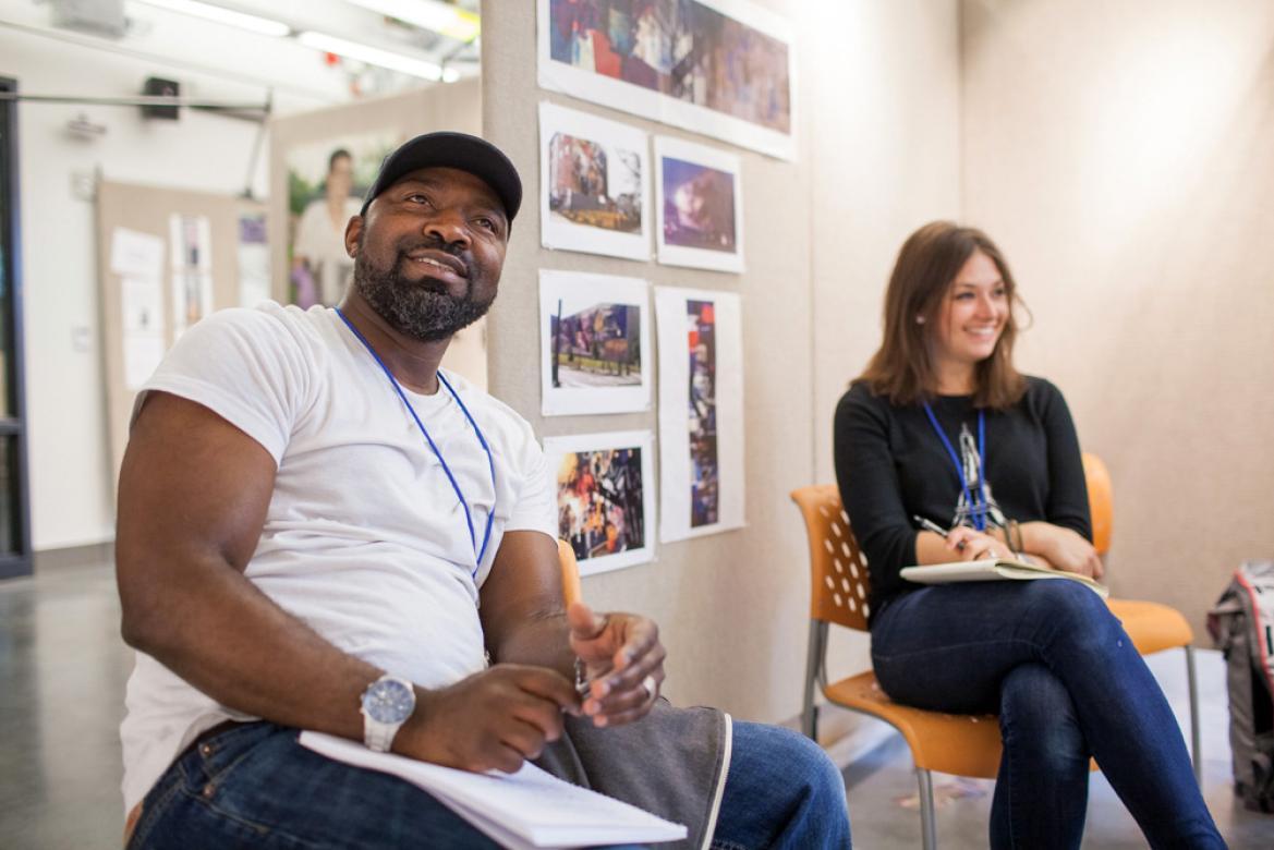 Students Marcel and Danielle sitting in class, smiling.