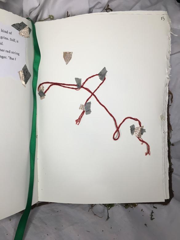 this page, at the end of "The Siren's Red String," shows red string taped down onto the page.