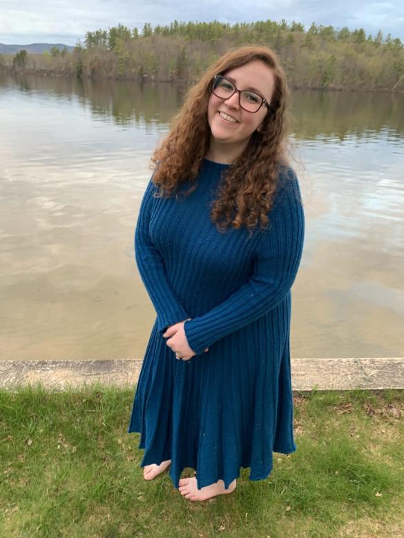 kiera rowe standing in front of lake in blue dress