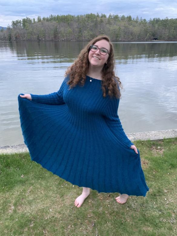 kiera rowe stadning in front of lake in blue dress