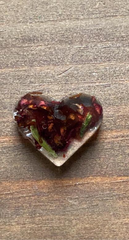 heart-shaped charm with flower petals inside