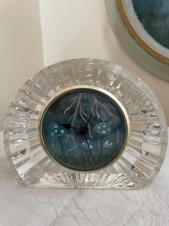 photo of a glass clock with a storm painted onto it
