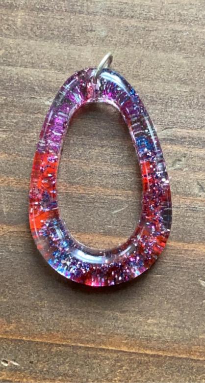 purple and red oval-shaped charm