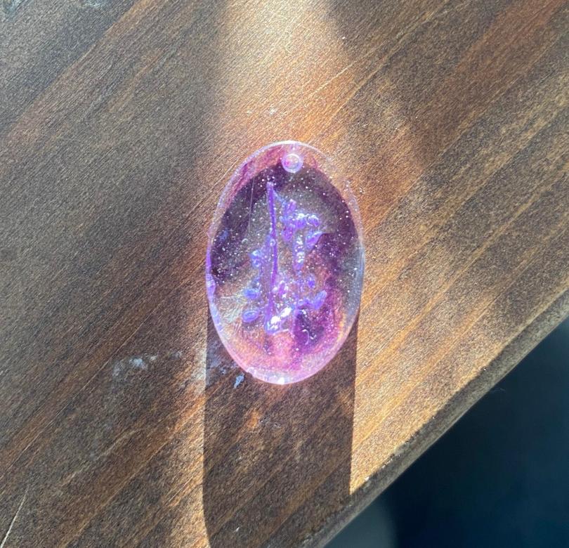 purple and pink sparkly oval-shaped charm