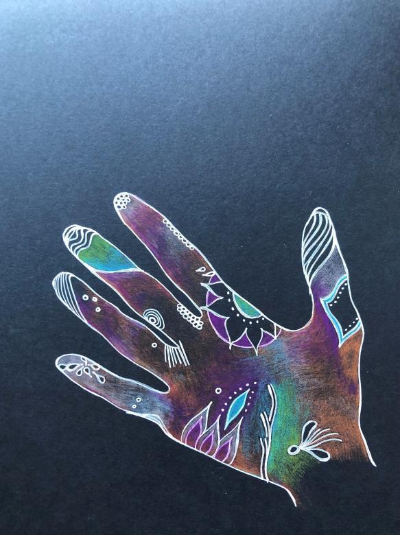 On a black background is the drawing of a hand outlined in white pen. On the hand are several colors including purple, orange, green and blue. The hand has several different designs drawn on it including flowers, squiggles, circles and lines. They are at the tips of the fingers and palm of the hand.