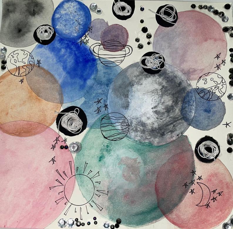 The background is several large circles that slightly overlap each other in the colors red, green, blue, orange, grey, and black. Drawn overtop of these circles are planets and stars. Around the piece are silver rhinestones and pieces of coiled up string.