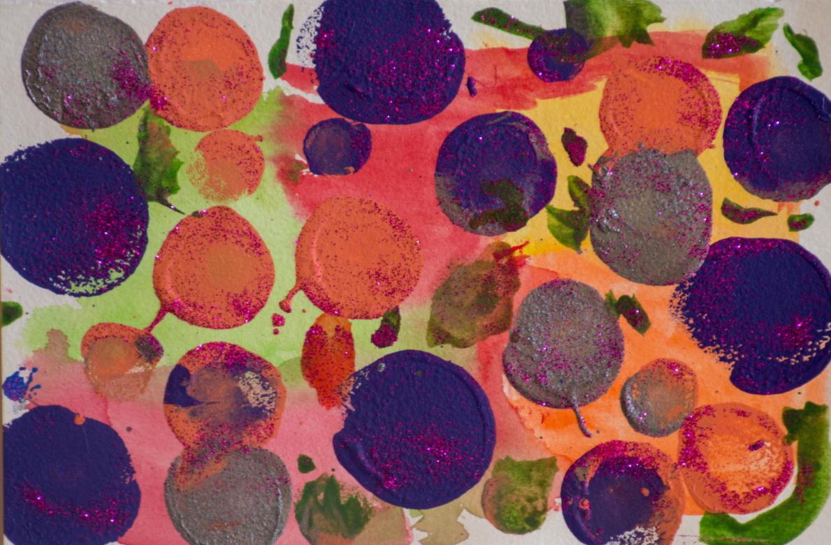 The background is segmented into different colors including light green, red, yellow, orange and pink. Painted on top of this background are circle in the colors purple, grey, and orange. Most of the purple circles are slightly larger than the others. The circles all have various amounts of pink glitter on them. In between and around the border of the circles are splotches of green paint which also have the glitter on them.