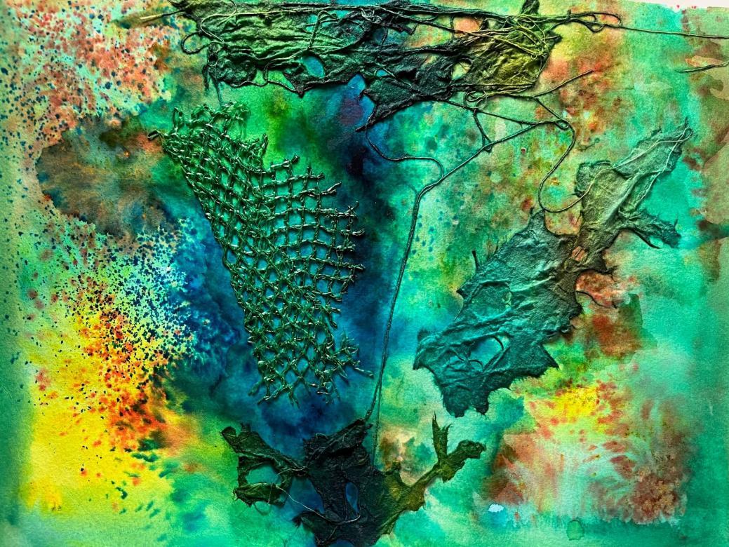 The colors are mostly blue/teal with yellow and red mixed in. In the center there is a larger splotch of blue that extends from the top of the piece to the bottom. Almost exactly in the center, slightly to the left, is a piece of fishnet that has been folded over onto itself. Around the fishnet are three additional pieces of cut cloth with holes. The materials are all connected by string which extends up the center of the piece. All the material has been painted over to match the background.