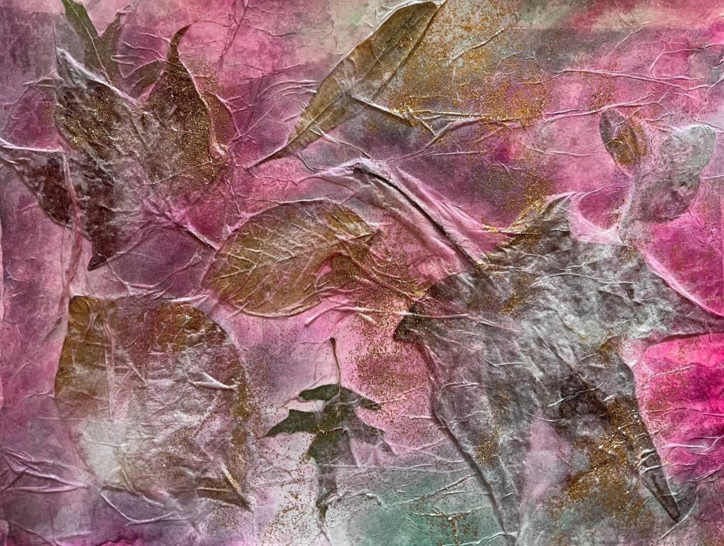 This piece has several leaves of different sizes and shapes on a pink and green background. The leaves are painted over with silver and gold. The piece also has gold glitter on it. 