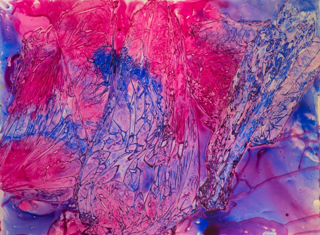 The piece is made up of the colors pink, purple, and blue. The colors blend together in areas. The piece is textured with lines creating many small lines and abstract shapes on the surface. 