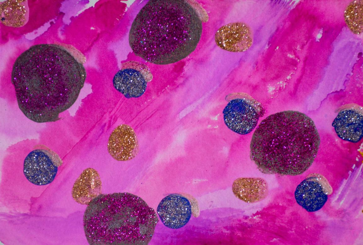 Painting: The background is completely pink and purple which are mixed together in various places. There are several circles painted on top of this background in the colors grey and blue. The grey circles are much larger than the blue ones. Additionally, there are a few circles made up of entirely gold glitter glue. The grey circles have pink glitter on it and the blue ones have silver glitter on them. 