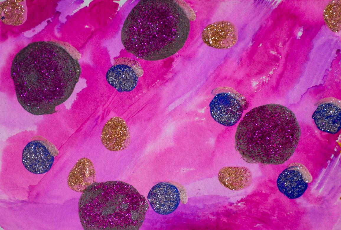 Painting: The background is completely pink and purple which are mixed together in various places. There are several circles painted on top of this background in the colors grey and blue. The grey circles are much larger than the blue ones. Additionally, there are a few circles made up of entirely gold glitter glue. The grey circles have pink glitter on it and the blue ones have silver glitter on them.