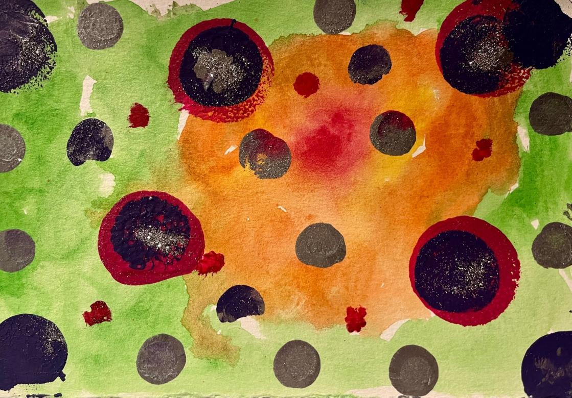 Painting: In the background, slightly off-center to the right is a small red blob. This is surrounded by a larger area of orange paint. The outer area is surrounded by green paint. Painted on this background are four large red circles which have slightly smaller dark purple circles painted on top of them. These circles have silver glitter on them. In each corner are painted purple circles of the same size. Some have glitter on them. Around the rest of the piece are many small grey circles and a few purple