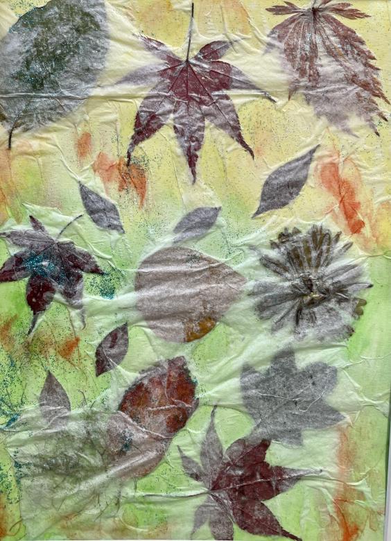 The background of this piece is yellow in the top half and green in the bottom half with orange splotches scattered throughout. Overlayed on top of this are leaves and flowers of various shapes and sizes. Overtop of them is a thin translucent layer. In the bottom left corner is some light blue glitter.