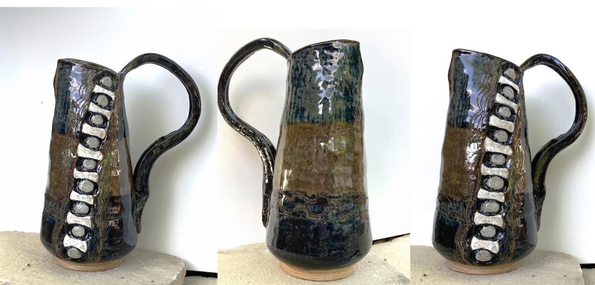 Three different angles of a blue and brown pitcher made from clay and fired with glaze