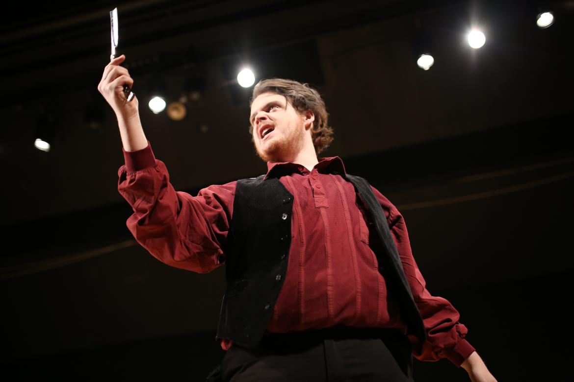 Student Ryan Livingston hoists a razor in his role at Sweeney Todd.