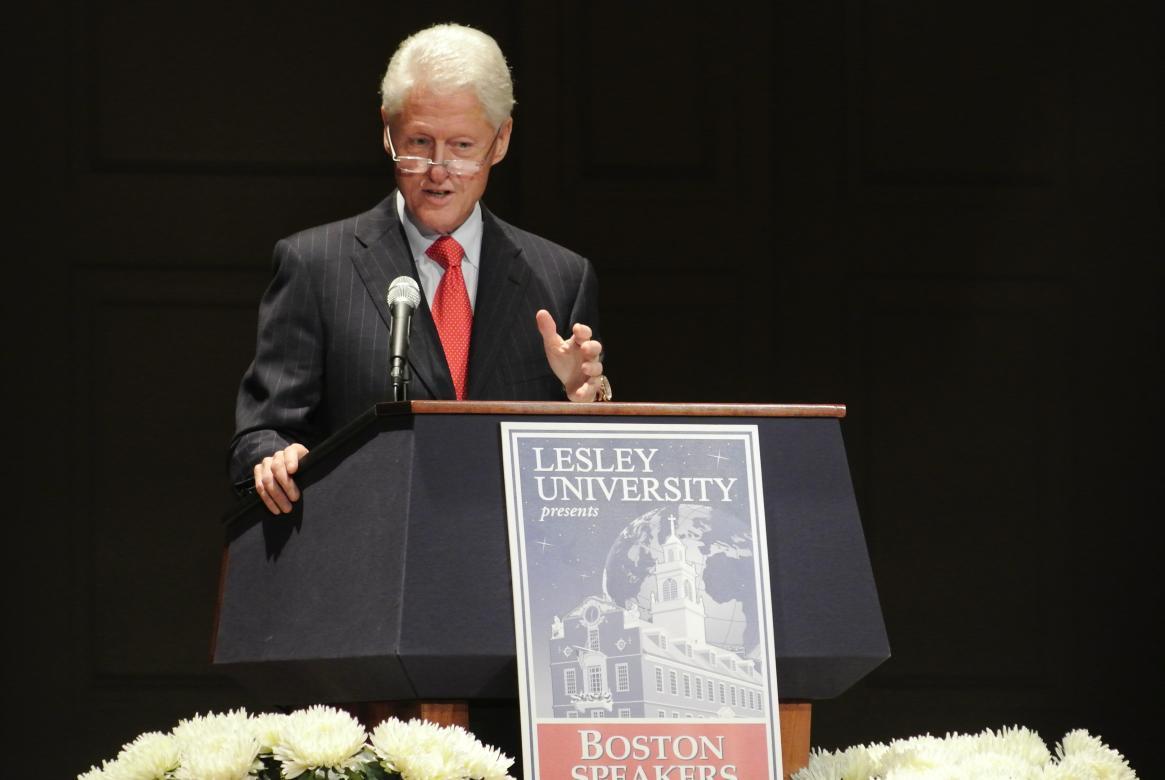 Bill Clinton speaking at a podium