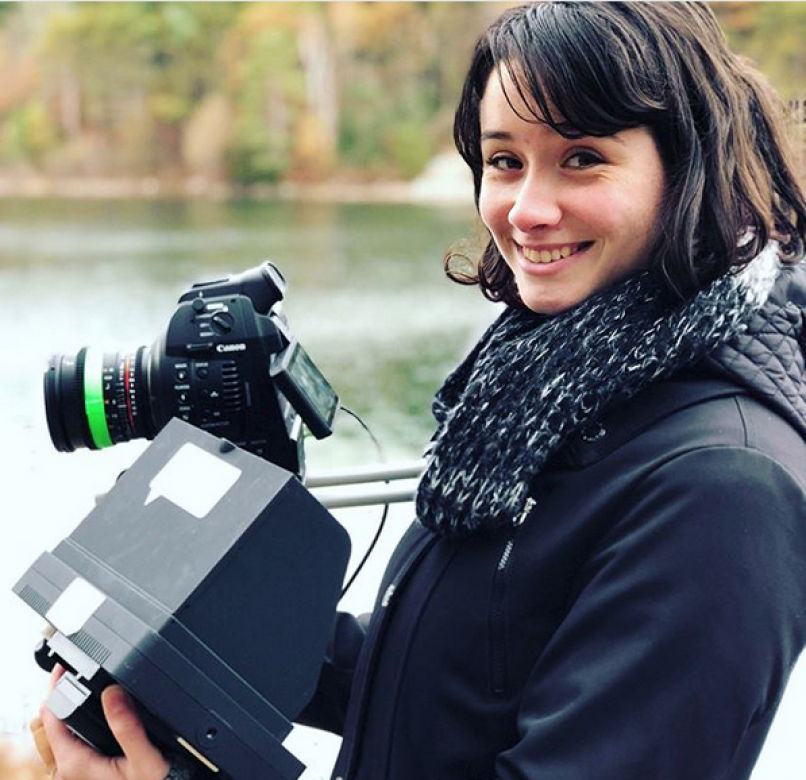 Anni Abbruzzese smiles for a picture while filming on location at a lake