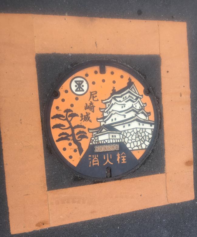 Manhole cover with traditional building.