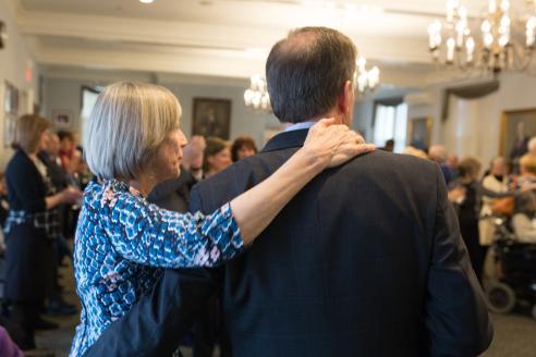 Beth Chiquoine puts her arm around President Moore