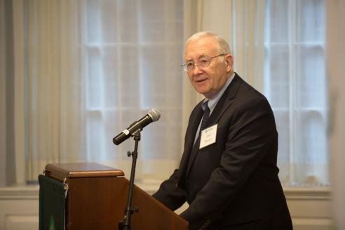 Donald Perrin speaks at a podium in Alumni Hall