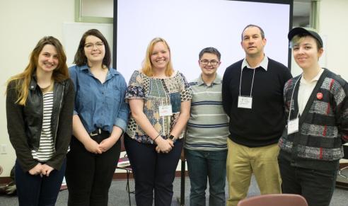 Six presenters pose for a picture after presentation