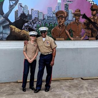 McKelvey stands with retired Sgt. Maj. John Canley in front of his image on a mural she created. He received the medal of honor two weeks later.