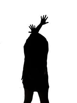 A silhouette of a person crossing their arms over their head, reaching their fingers out.