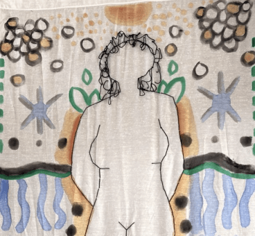 Close up of top half of large stitched black outline of a figure with no features other than black stringy short hair. Around the figure are orange, blue, green, and black symbols and shapes creating a landscape. 
