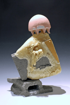 Abstract sculpture of cement blocks, pale yellow goop, and a pink dome with spikes.