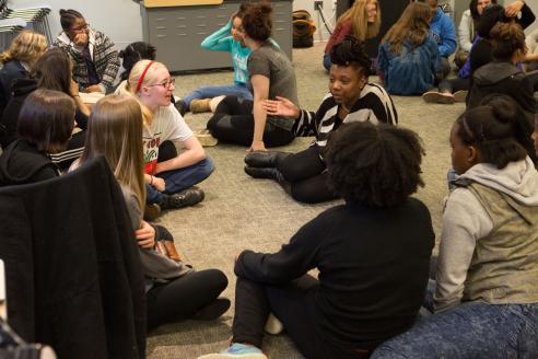 Girls sitting on the floor.