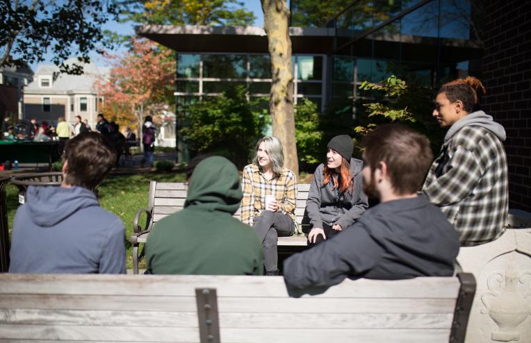 Students drinking coffee outside on the Lesley campus.